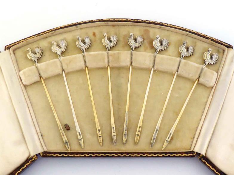 A set of eight silver-gilt cocktail sticks with cockerel terminals by Adie Brothers, Birmingham,