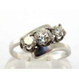 A three stone diamond ring, obliquely set with three tapering old cut brilliants totalling approx.