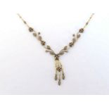 A diamond necklace, composed of central pave set 'flowering trellis' links, to a triple drop en