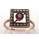 A late 19th century ruby and seed pearl ring, the central round cut ruby 4.5mm, milligrain set, in a