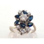 A sapphire and diamond cluster ring, composed of a central brilliant (approx. 0.27 carat) in a spray