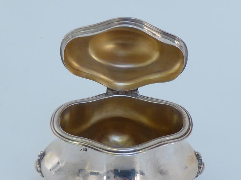 A silver tea caddy of oval quatrefoil form, marks indistinct, Chester, 1915, the four claw feet - Image 2 of 4