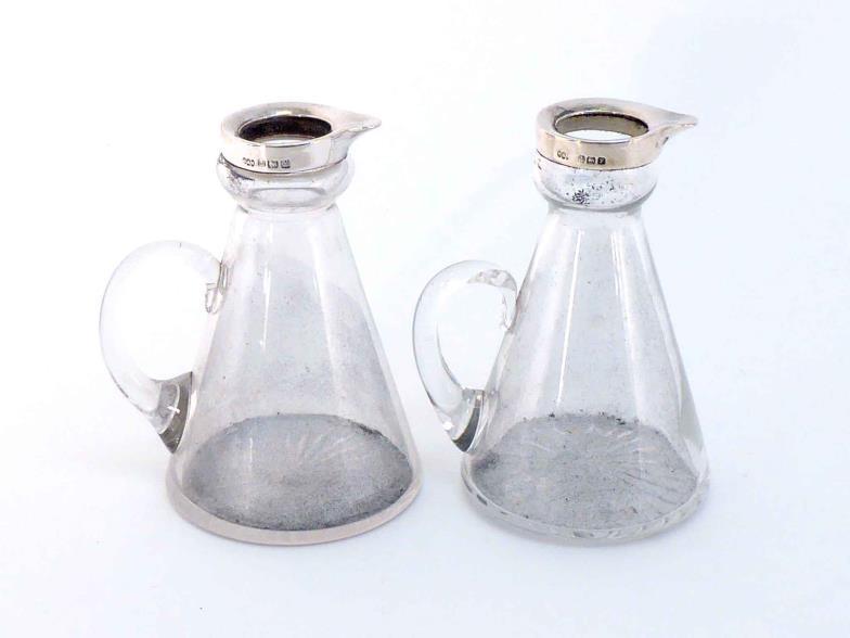 A pair of silver-mounted glass whiskey noggins by Hukin & Heath, Birmingham, 1923, plain tapering