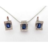 A sapphire and diamond pendant and earring suite, the pendant with a central oval cut stone, in a