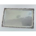 A Turkish white metal tray stamped "900", 20th century, rectangular with foliate scroll border,