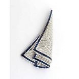 YACHTING INTEREST: a sapphire and diamond brooch, of triangular 'sail' design, pave set overall with