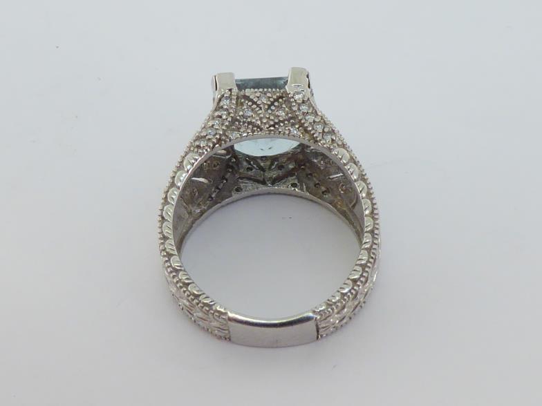 An aquamarine and diamond dress ring, the central emerald cut stone 11 x 9 x 6.2mm (approx. 4.07 - Image 3 of 4