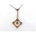 An early 20th century aquamarine and seed pearl pendant, stamped '9ct' verso, 4cm long, to a fine