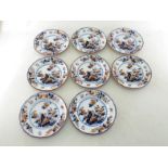 A set of eight Minton polychrome dessert plates with shaped borders and decorated with flowers and a