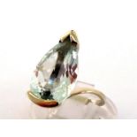 An aquamarine dress ring, the pendeloque cut stone 6 x 9.9mm, in a white metal mount (tests 18 carat