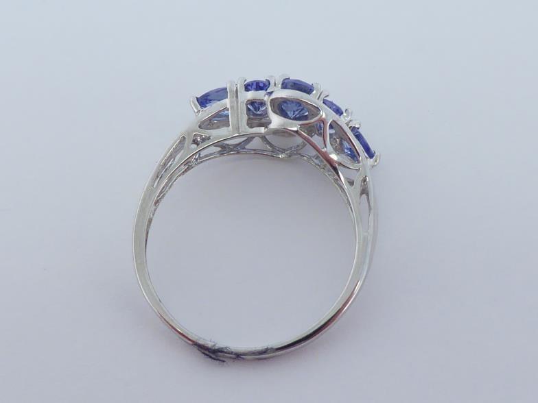 A 14 carat white gold and tanzanite ring, set with five graduated oval and pear cut stones, the - Image 2 of 3