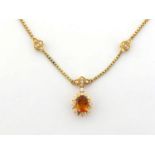 A citrine and diamond necklace, the cluster pendant composed of a central oval cut citrine in a