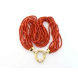 An Italian 18 carat gold and coral ten strand necklace, composed of uniform 3.7mm beads, to an O-