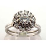 A diamond cluster ring by Bucherer, the central brilliant approx. 0.25 carat, in a segmented