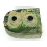 An unusual partly iridescent green glazed ceramic piece with enclosed spherical compartment and