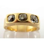 A French 18 carat gold and diamond three stone ring, rub over set with three mine cuts, the shank