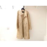 A lady's cream-coloured coat by J. Mendel of Paris, with ribbed stitching,