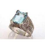 An aquamarine and diamond dress ring, the central emerald cut stone 11 x 9 x 6.2mm (approx. 4.07