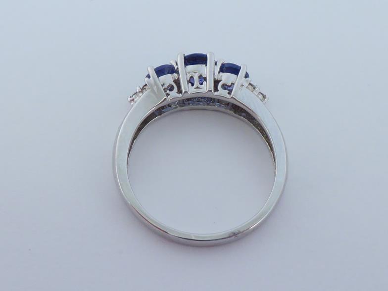 A 14 carat white gold, tanzanite and diamond ring, set with three graduated central round cut - Image 2 of 5