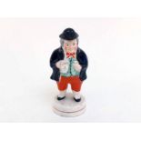 A ceramic Toby Philpott pepper, the figure in traditional stance holding jug and glass, the