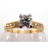 An 18 carat gold and diamond dress ring, the central brilliant approx. 0.34 carat, to pave set