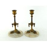 A pair of Italian candlesticks, the turned gilt brass columns with nozzles and central knop having