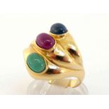A ruby, sapphire and emerald dress ring, set obliquely with three oval cabochons, each 7.1mm long,
