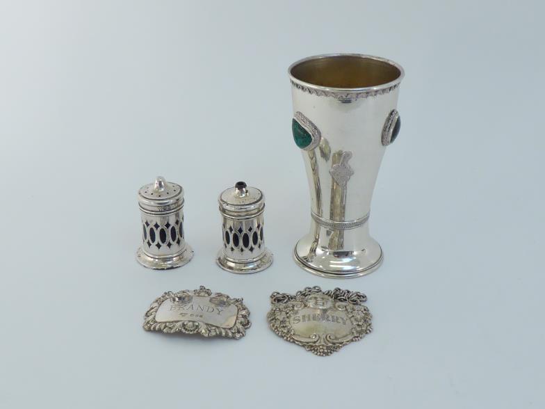 A group of silver comprising:- a pair of pierced cylindrical condiments with blue glass liners, - Image 6 of 7