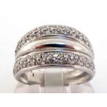 A diamond dress ring, the tapering bezel pave set top and bottom with two rows of small