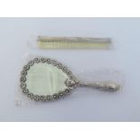 A Portuguese silver handmirror and silver-backed comb, .935 standard, the ovoid mirror with border