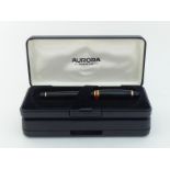 Aurora, a black resin roller ball pen, in Aurora box, together with another Aurora box CONDITION: