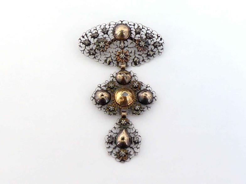 A 19 century Continental diamond stomacher, the graduated filigree segments (tests 14 carat gold)