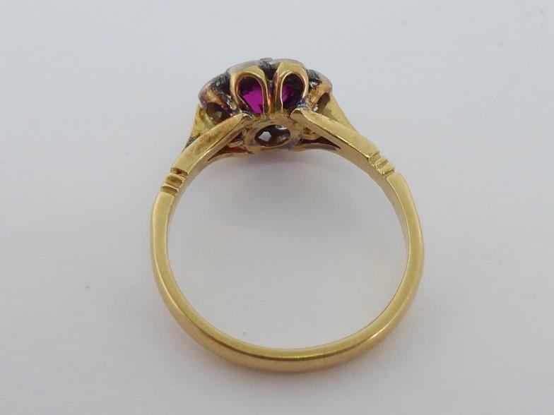 A mid 20th century synthetic ruby and diamond cluster ring, the central round cut ruby 5.4mm, in a - Bild 2 aus 3