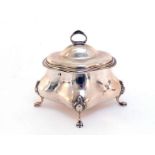 A silver tea caddy of oval quatrefoil form, marks indistinct, Chester, 1915, the four claw feet