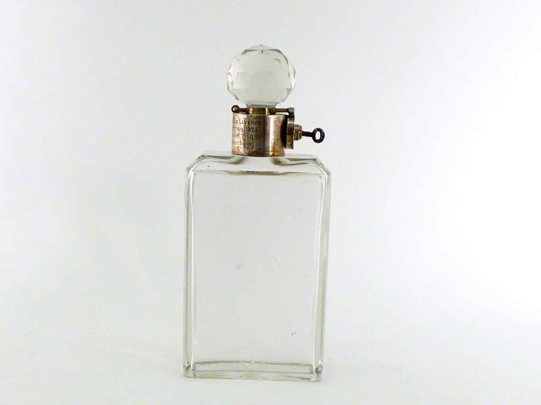 A silver-mounted glass decanter, the silver collar with patented lock securing the diamond-cut