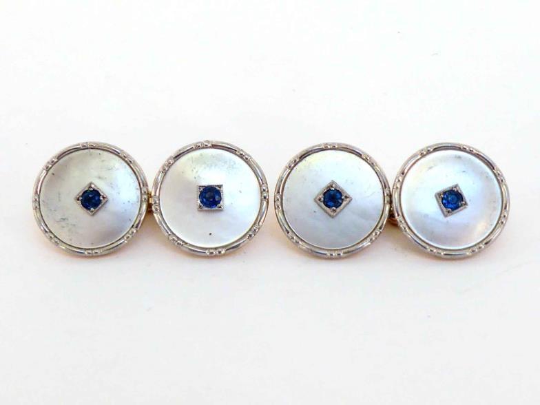 A pair of Edwardian 18 carat, platinum, sapphire and mother-of-pearl cufflinks, 14mm diameter,