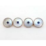 A pair of Edwardian 18 carat, platinum, sapphire and mother-of-pearl cufflinks, 14mm diameter,