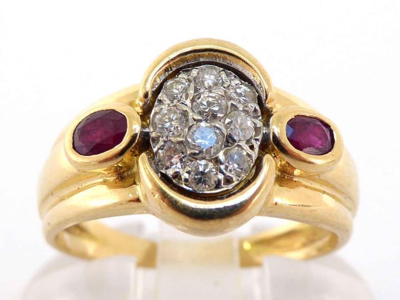 A French 18 carat gold, diamond and ruby ring, with a central pave set oval of small brilliants,