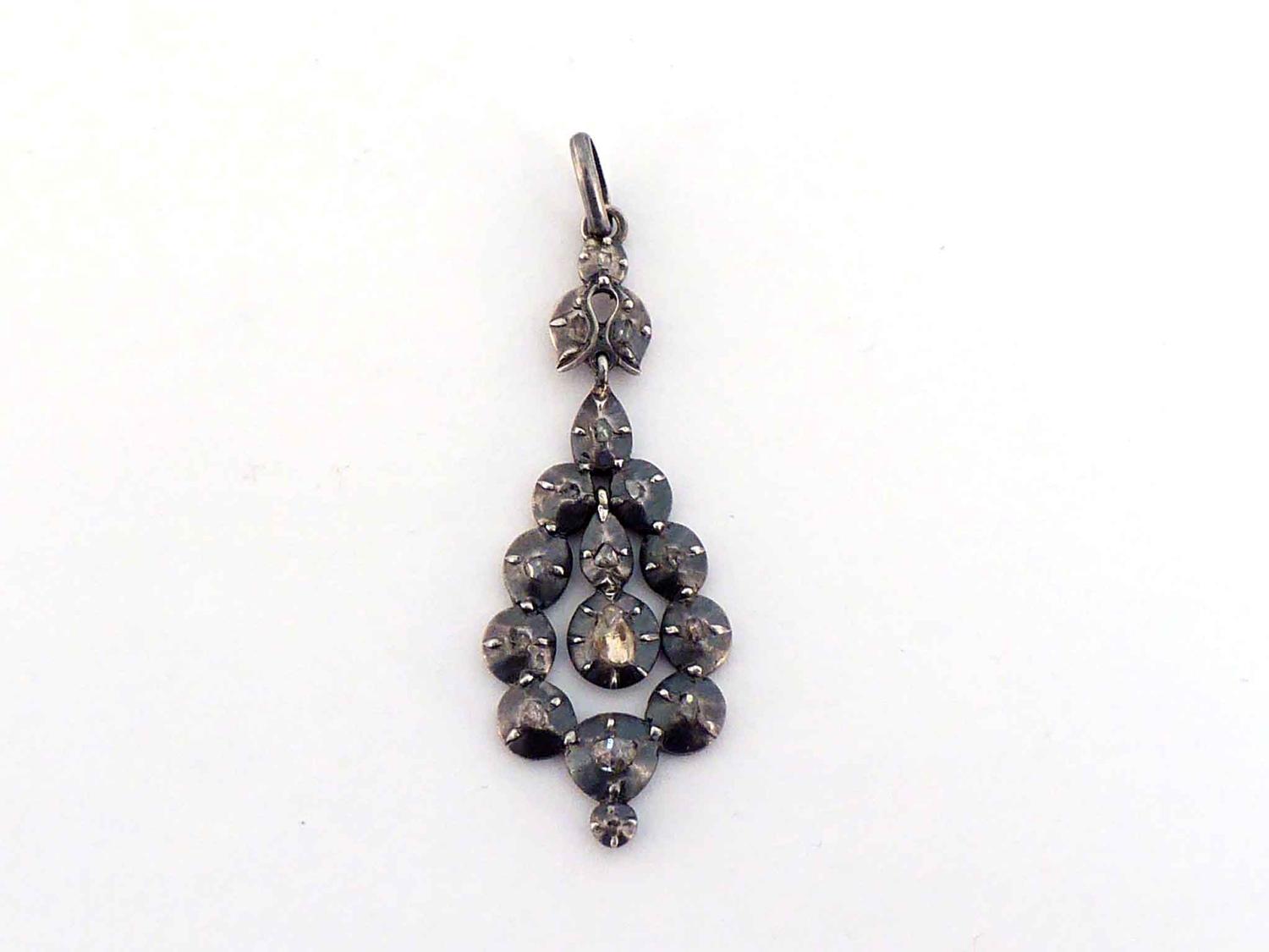 A diamond pendant, suspended to the centre with a small rose cut, the surround accented with small