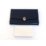 A black leather clutch by Suzy Smith, with gilt metal fittings, 32 x 19cm, together with a small