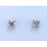 A pair of 18 carat white gold and single stone diamond ear studs, the two old brilliants each 3.