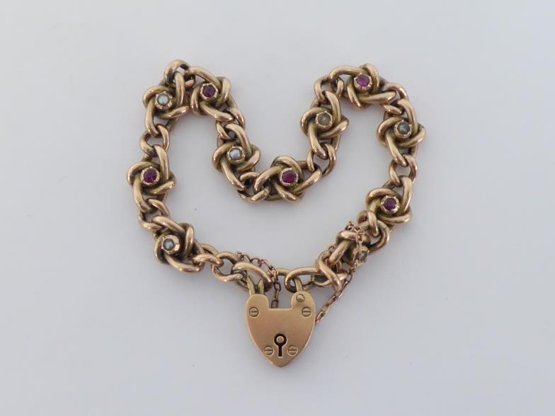 A 9 carat gold split pearl and ruby curb link bracelet, to a heart shaped padlock clasp, fully - Image 2 of 4