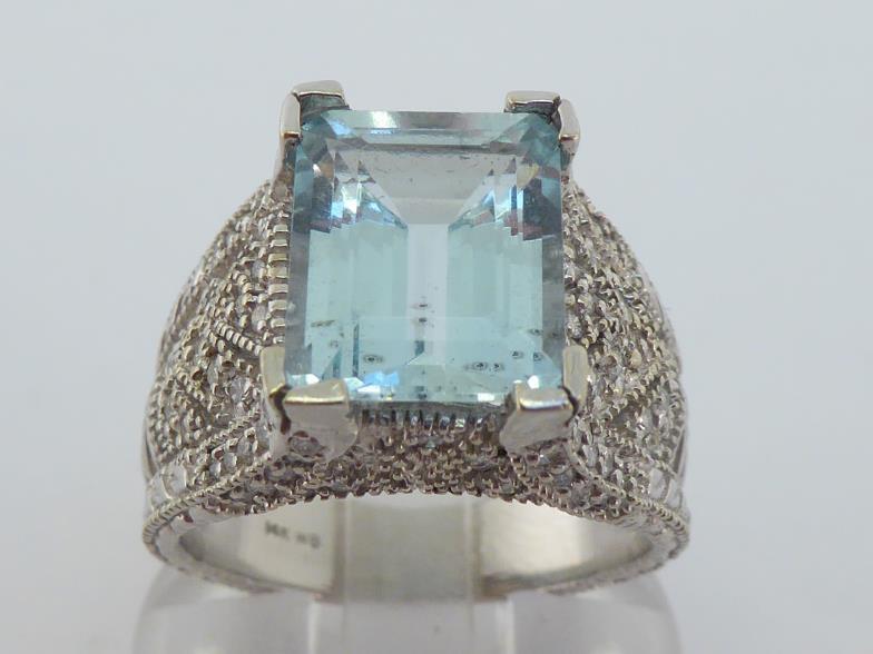 An aquamarine and diamond dress ring, the central emerald cut stone 11 x 9 x 6.2mm (approx. 4.07 - Image 2 of 4