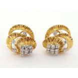 A pair of 18 carat gold and diamond clip earrings by Kutchinsky, the textured three tiered spirals