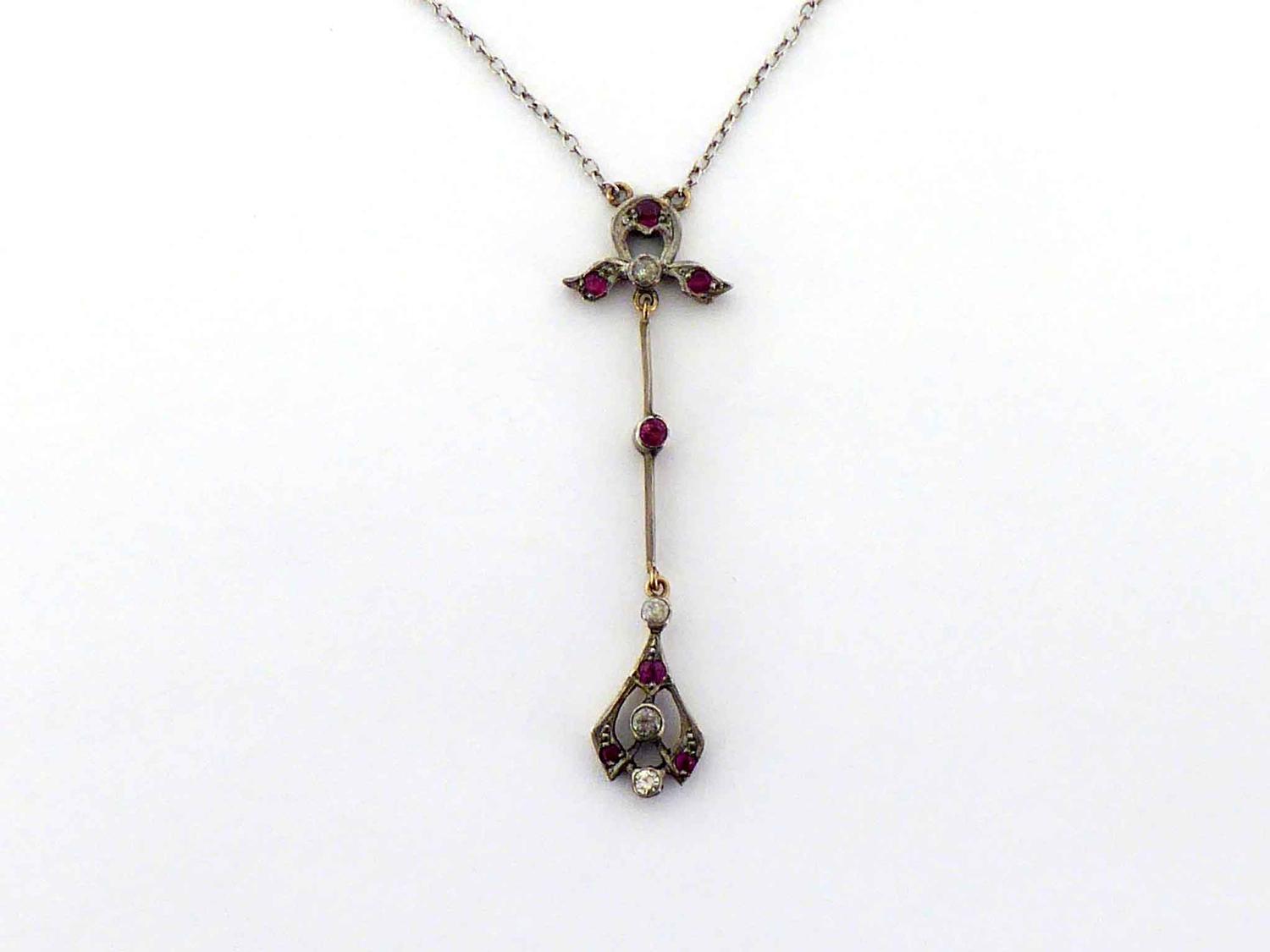 An early 20th century diamond and ruby pendant necklace, set overall with alternate brilliants and