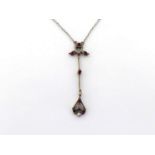 An early 20th century diamond and ruby pendant necklace, set overall with alternate brilliants and
