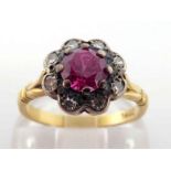 A mid 20th century synthetic ruby and diamond cluster ring, the central round cut ruby 5.4mm, in a