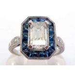 A diamond and sapphire cluster ring, the central rectangular cut diamond 8.1 x 4.8 x 2.9 (approx.