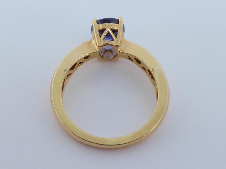 An 18 carat gold and tanzanite ring, the central oval cut stone approx. 2 carats, the shank fully - Image 3 of 6