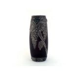 An Art Nouveau black glass vase of swollen cylinder shape with embossed pewter overlay of a wisteria